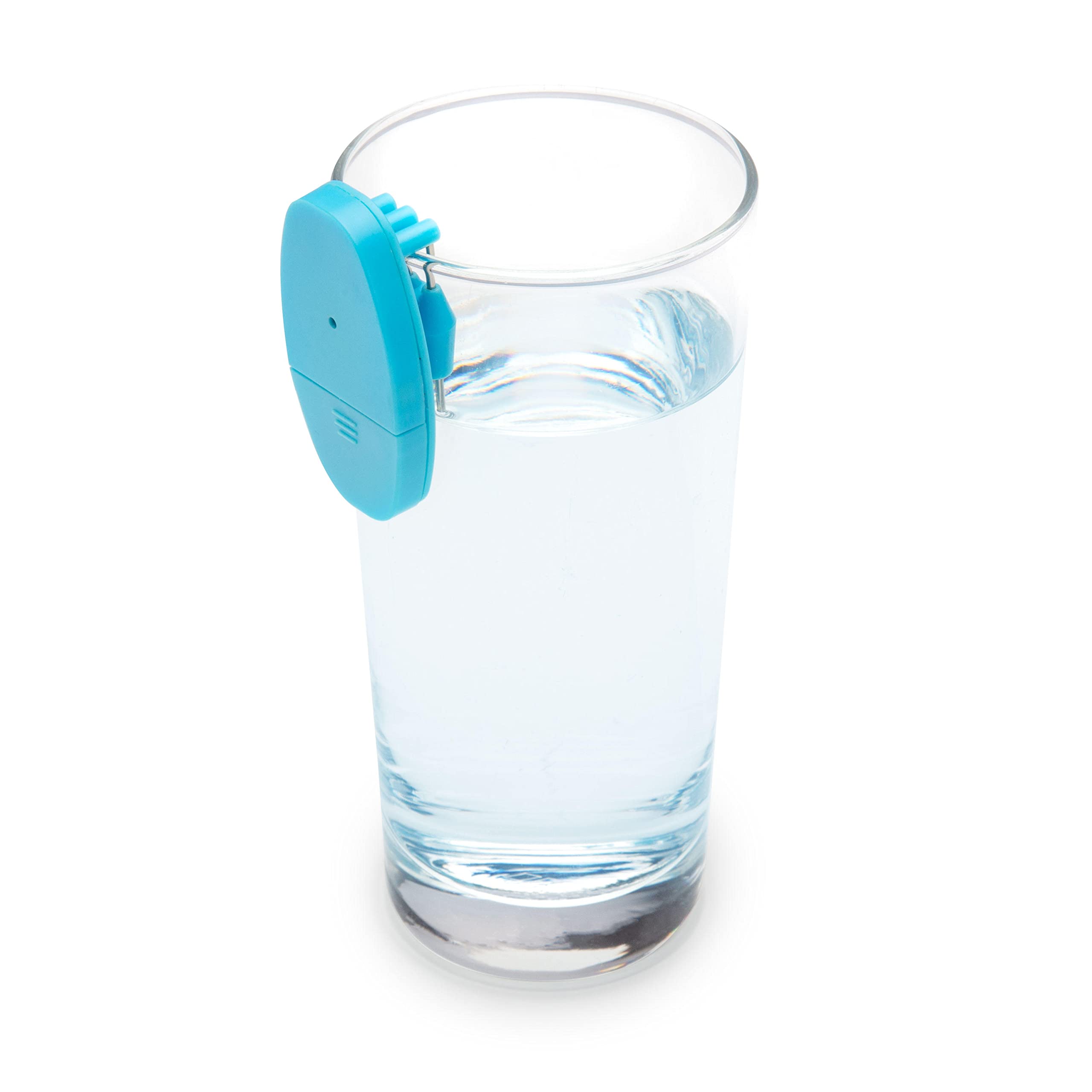 A bright blue liquid level indicator clipped onto the rim of a tall glass of water: the flat oval body hangs outside the glass while its two metal sensor prongs dip just inside the rim, positioned so the device beeps or buzzes the moment the rising water touches them.